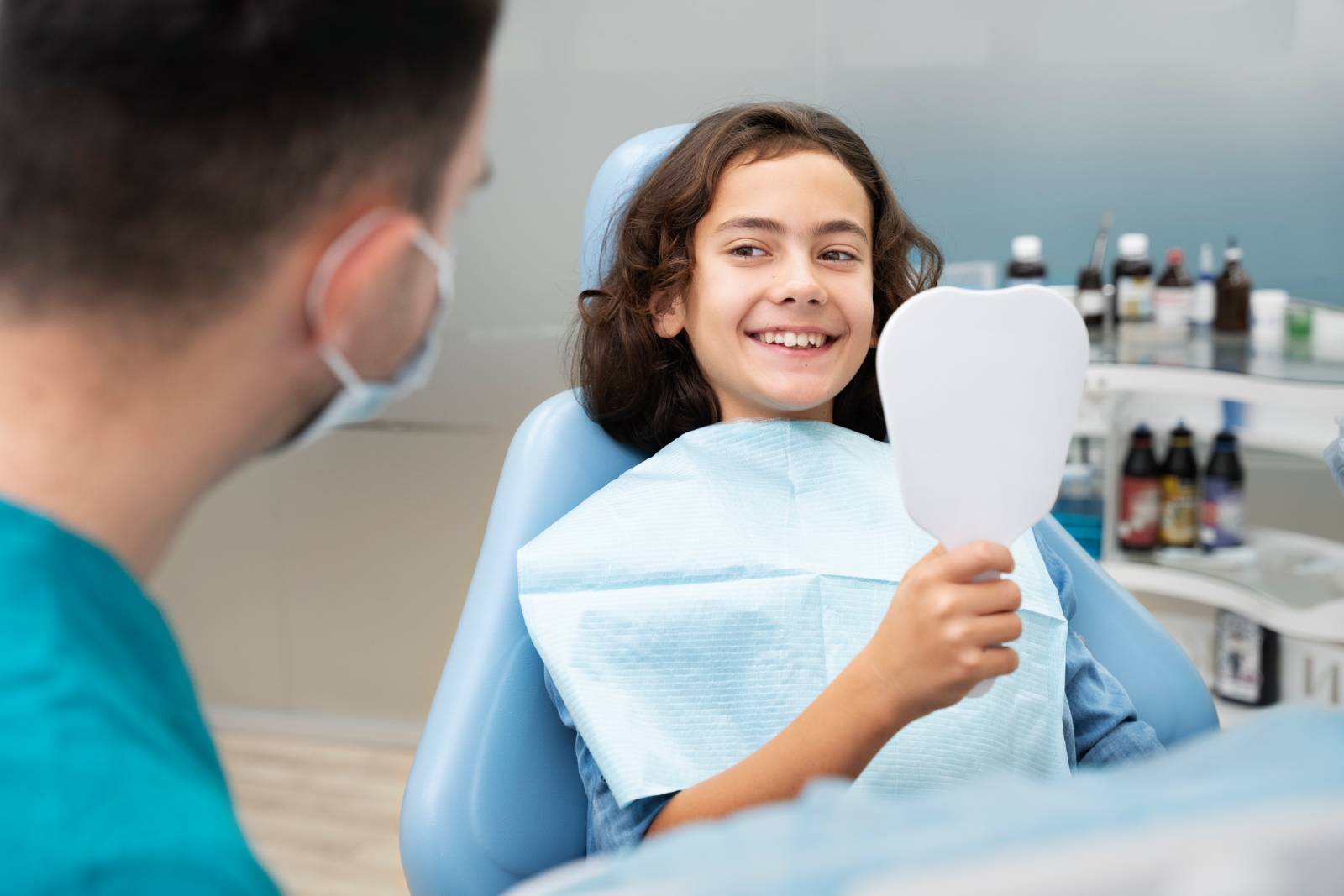 a girl smiling after receiving a dental checkup and cleaning at a pediatric dentist in Red Deer