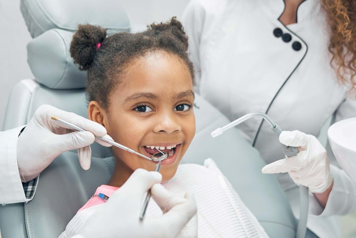 A little girl at the dentist for a blog post titled, "What is a pediatric dentist?"